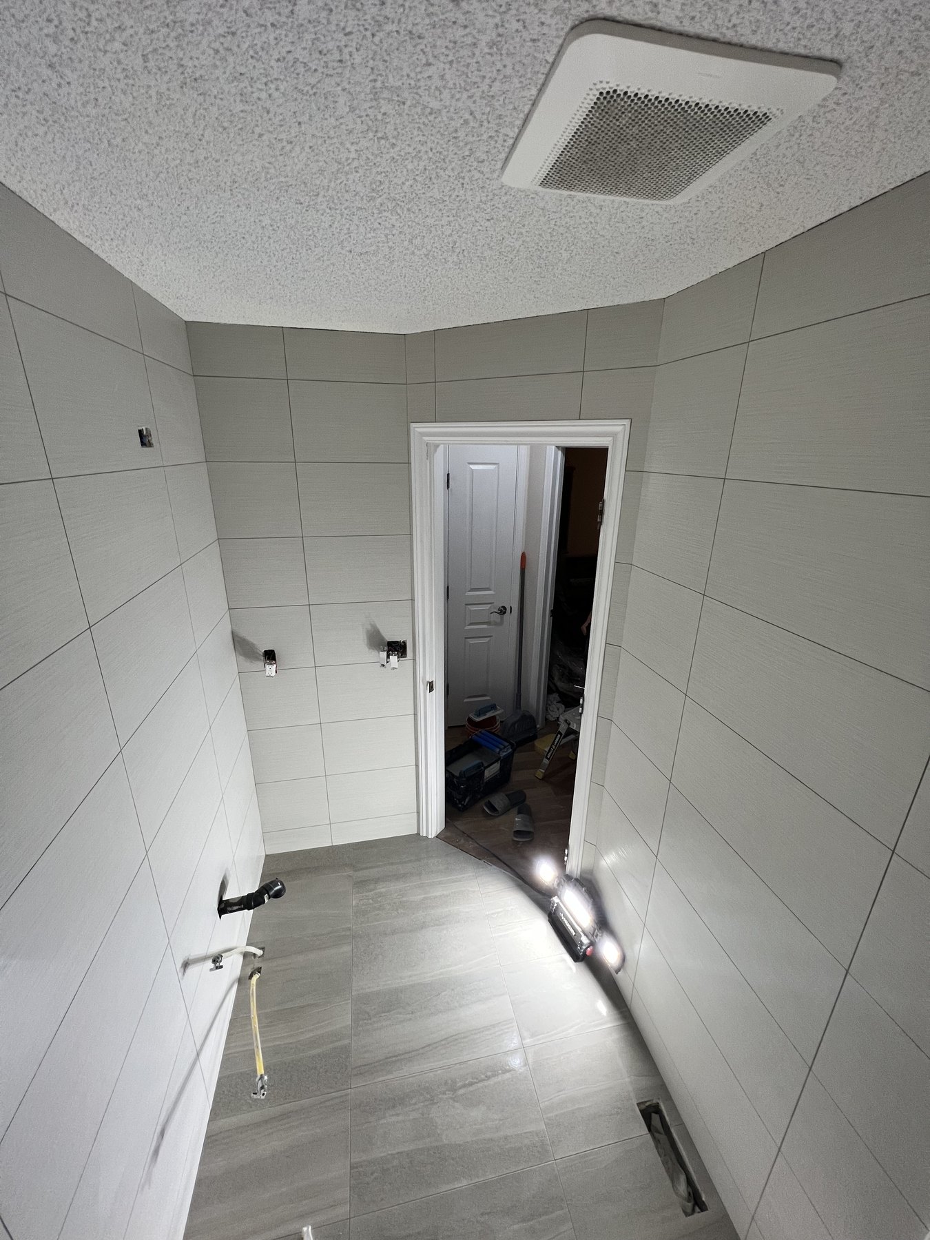 Large-format gray bathroom tile installation