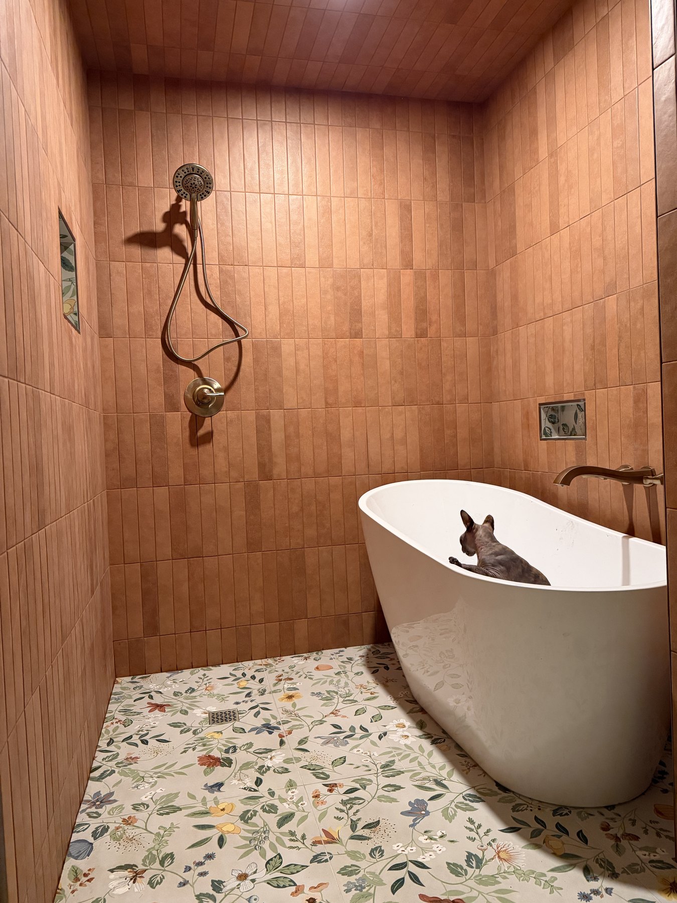 Terracotta tiled bathroom with freestanding tub