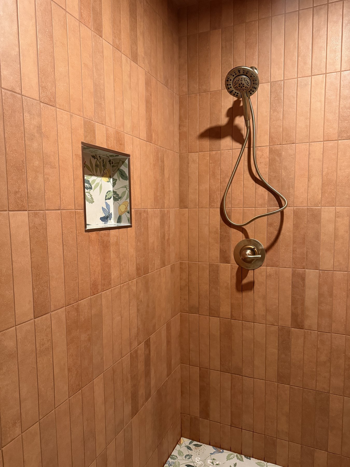 Terracotta shower tile and inset detail