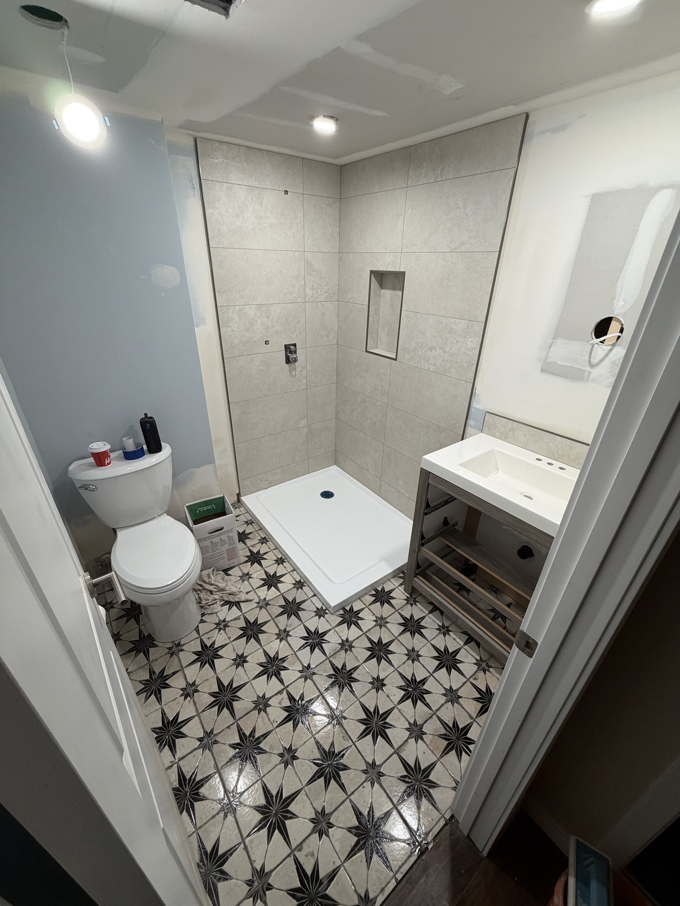 Completed bathroom with patterned floor tile